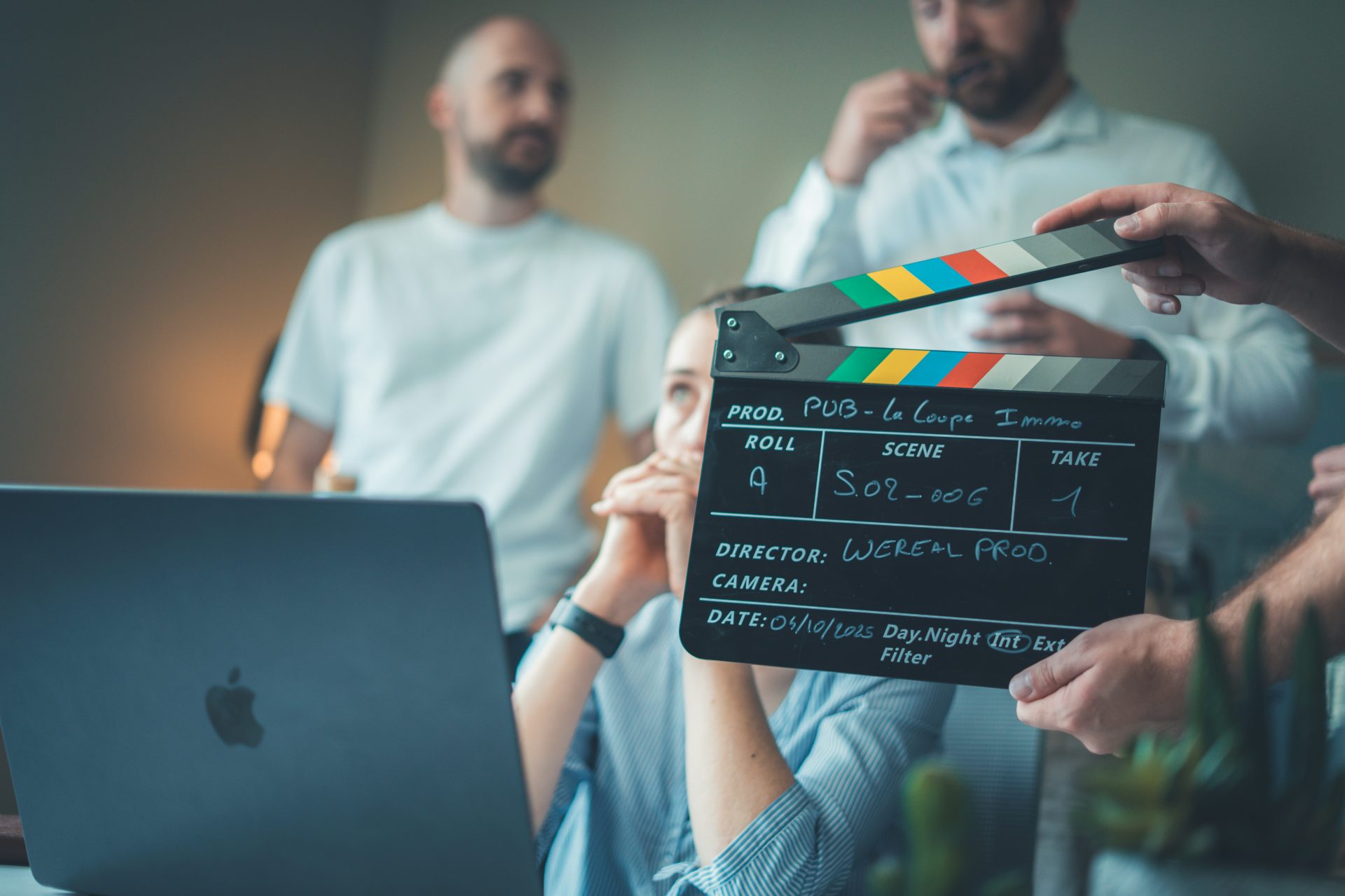 Filming a scene with a clapperboard and laptop